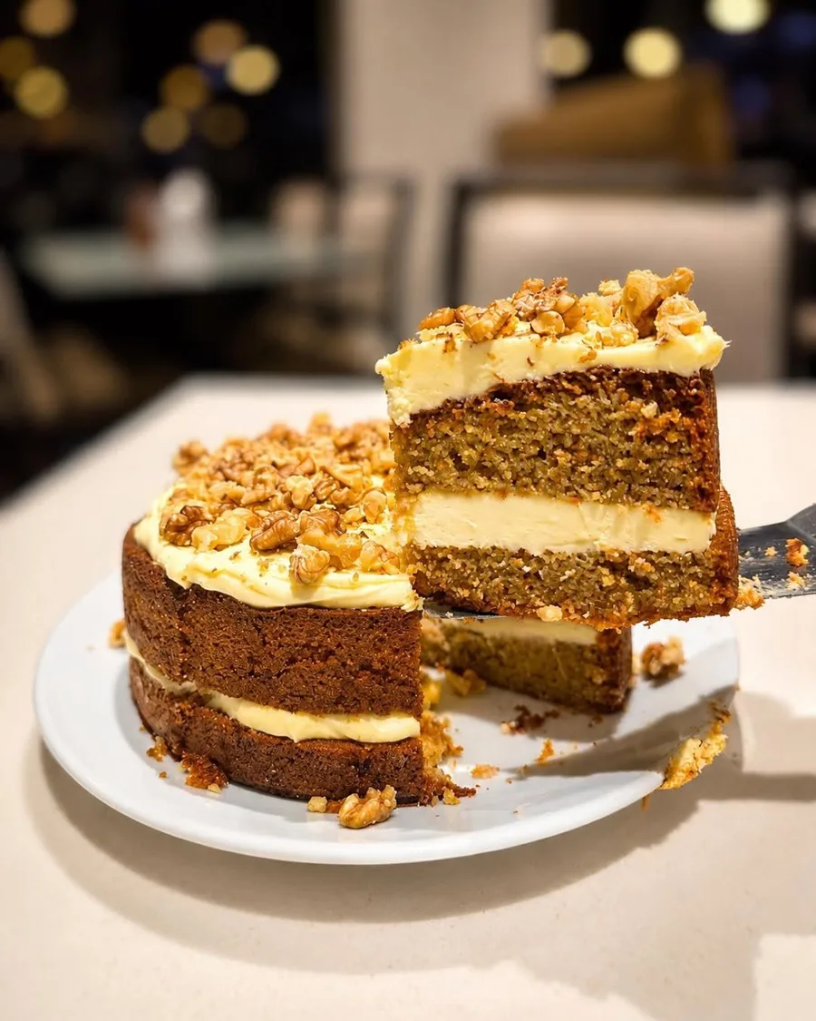 Slice of carrot cake with cream cheese frosting and walnuts at Cafe Cosy Moss Vale
