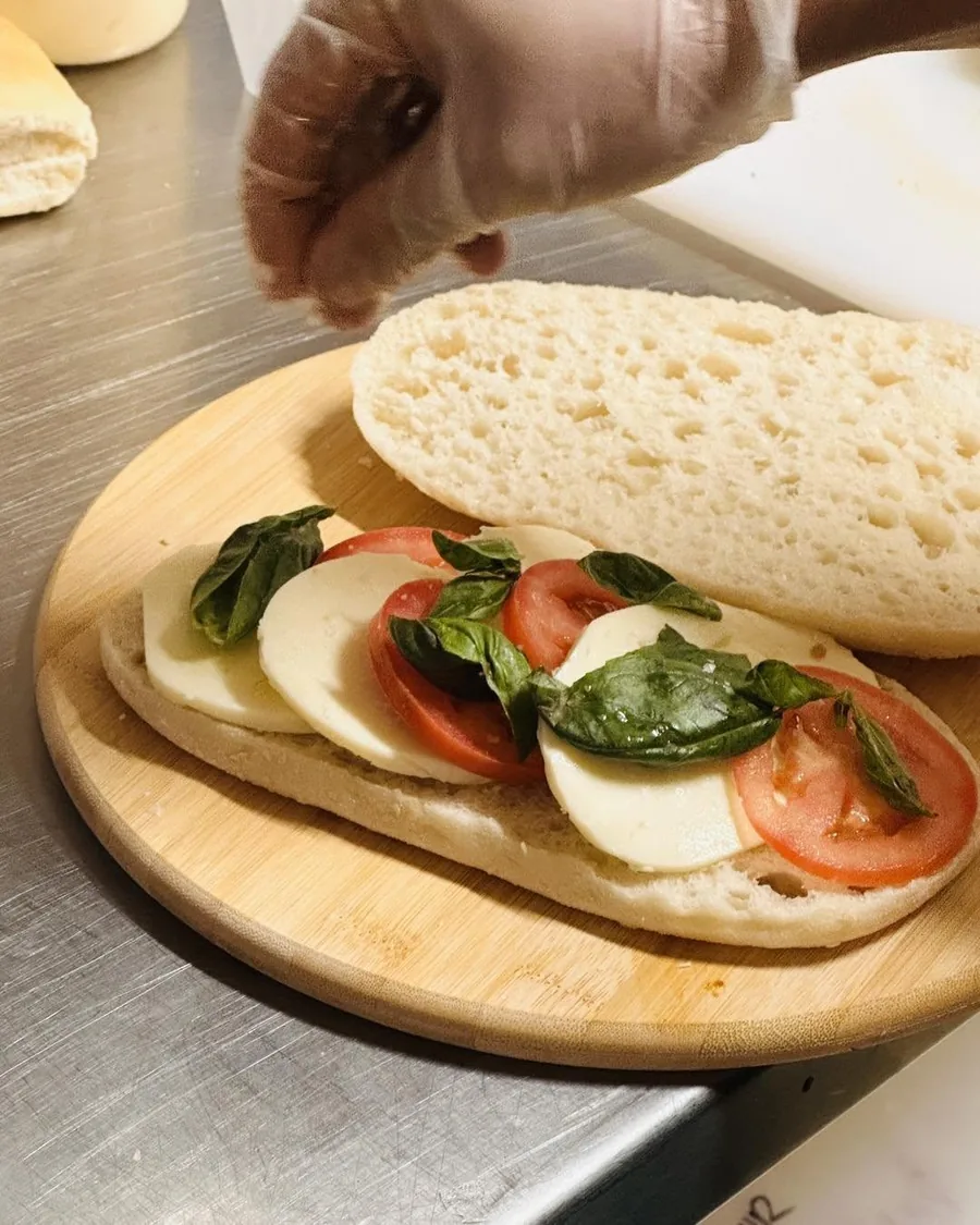 Caprese sandwich with mozzarella, tomato and basil on a board at Cafe Cosy Moss Vale