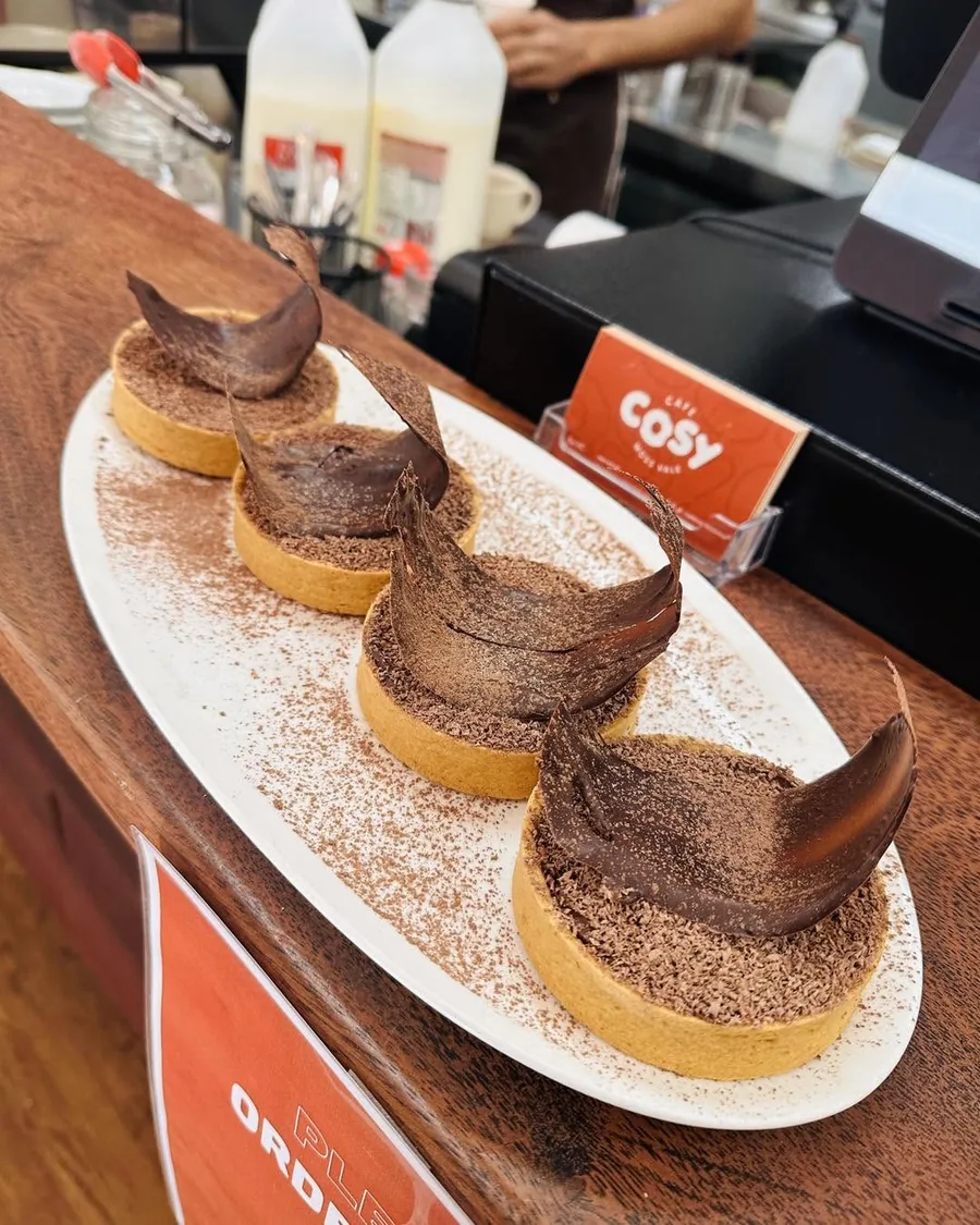 Chocolate tarts dusted with cocoa on a plate at Cafe Cosy Moss Vale